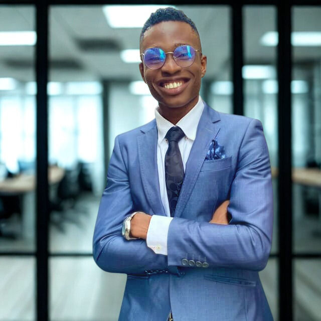 Doosu Bere wearing a suit in an office as the Business Development Officer at RIS International